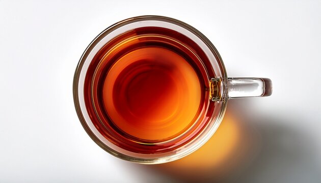 top view of clear tea in a glass cup isolated on white background clear tea in a glass cup viewed from the top showing the rich amber color and smooth surface of the beverage