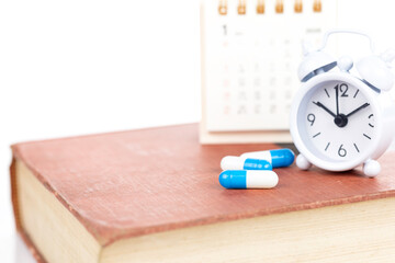 Medication schedule and health reminder for treatment time, isolated on white background with clipping path.