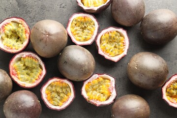 Fresh passion fruits on grey table, flat lay