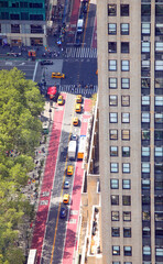 top view of the street with taxis and buses and cars that seem small