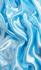 Dynamic folds of rich blue silk fabric captured in motion, showcasing a luxurious texture with a graceful flow.