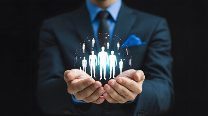 Business leader's hands protectively holding a glowing network of diverse people, symbolizing global connection and teamwork.