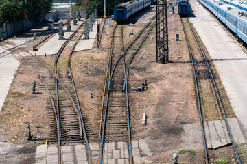 Complex track layout featuring converging rails, semaphore signal, turnout mechanisms, station...