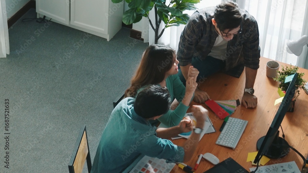 Poster close up of smart business team hands looking at color palette at table while throw paper in the air