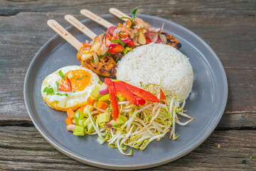 Delicious grilled chicken skewers with rice and fresh vegetables, perfect meal concept