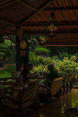 People dining at a tranquil outdoor cafe surrounded by lush greenery and natural light