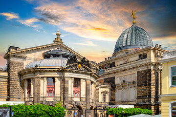 Dresden Art Academy with dome and golden Fama sculpture at sunset, Germany