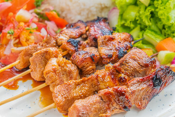 Delicious grilled meat skewers with fresh salad, perfect for food blogs, restaurants, and menus