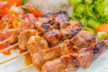 Delicious grilled meat skewers with fresh side dishes perfect for outdoor dining and events