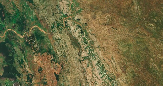 Top shot on meanders of river in moderate climate. Camera is zooming in. Animation based on image by NASA