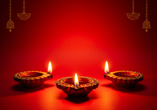 Three Diwali Diya in the red background. Celebrations Deepavali festival of lights.