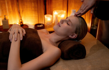 Caucasian woman enjoying relaxing anti-stress head massage and pampering facial beauty skin...