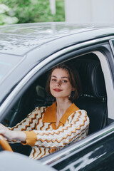 Portrait of a woman driving a car, smiling confidently from the driver's seat, with natural...