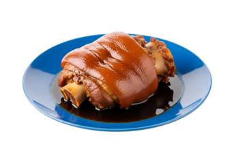 A glistening, glazed pork knuckle sits on a vibrant blue plate, showcasing rich, savory colors against a stark black backdrop.