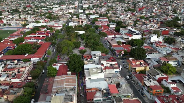Aerial footage moving across Chilpancingo Alameda with surrounding trees and colonial structures