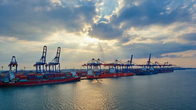 Epic 360-degree drone flythrough massive international port, container cranes lifting cargo containers perfect oil trade flags international cooperation synchronized logistics, cinematic sequences