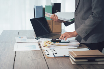 Efficiency in Administration: A person diligently manages a desk, meticulously organizing paperwork, documents, and records with focused intention.