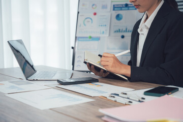 Analyzing Data: A businesswoman intently examines the data to make the better decision in a bright and well-lit office, embodying focus, and the spirit of innovation in modern business settings.