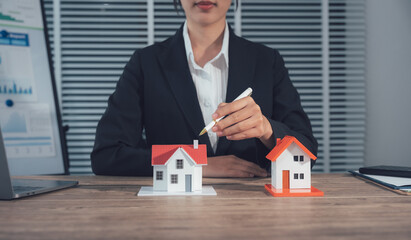 Property Analysis: A professional assesses two model homes, a representation of real estate investment and property valuation. With the precision of real estate
