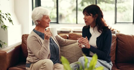 Coffee, talking and woman with senior mother on sofa in home for advice, bonding or connection. Happy, tea and female person with elderly mom for conversation, catch up or discussion in living room. - Powered by Adobe
