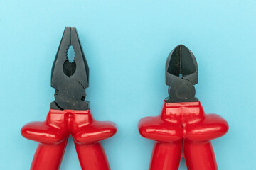 Red Handled Pliers and Wire Cutters on Blue Background