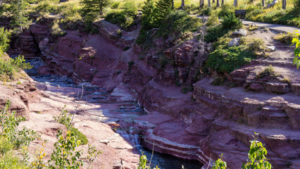 Red Rock Canyon in Waterton lake national park of Alberta, Canada, a natural gorge where brilliant...