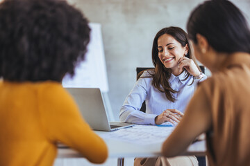 Professional Women Engaged in a Vibrant Business Meeting Indoors