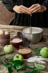 Homemade traditional classic apple pie step by step recipe and making process with organic apples, raw dough, fresh eggs, cane sugar, and rustic food styling