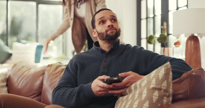 Man, ignore and conflict with phone on sofa for fight, argument or disagreement in home. Frustrated couple, woman and separation with mobile smartphone for living room dispute or cheating affair
