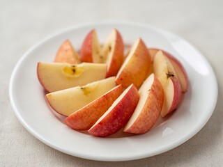 Segments of Pyrus Malus on a Ceramic Surface, illuminated with soft daylight.