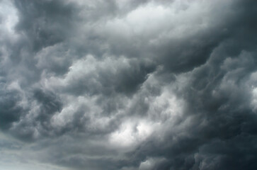Cumulus gray storm clouds forming dramatic textured sky creating moody and powerful natural weather background scene