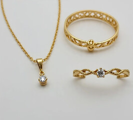 A stunning gold chain necklace with a pendant resting on a black background