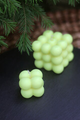 Handmade beeswax bubble candles in trendy cube design, bright yellow-green color. Stylish eco-friendly home decor and perfect modern gift for any occasion.