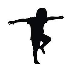 Silhouette of a Young Boy Playing Airplane Spreading Arms and Lifting Knee