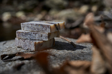 Artisan handmade soap bar with rustic textures, styled in nature. Sustainable skincare product blending purity, plant-based beauty, and wellness lifestyle