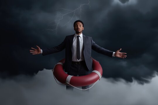 African young male in suit with lifebuoy in stormy cloudy sky with lightning