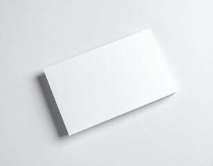 Blank business card mockup lying flat on a white surface