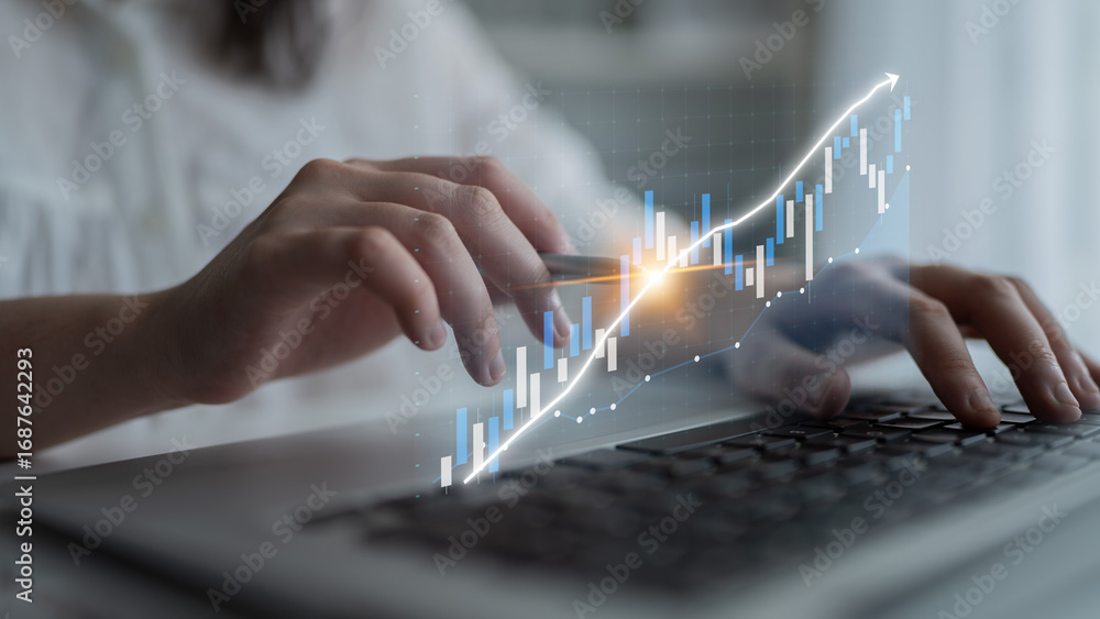 Poster a person is analyzing financial data on a laptop with a digital graph overlay showing upward trends 