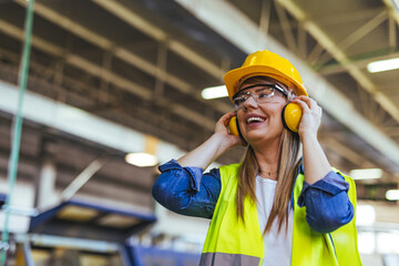 Smiling Female Worker in Safety Gear Inside an Industrial Environment