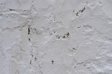 Background texture of an old wall made of clay and straw painted white. Abstract background and texture for design.