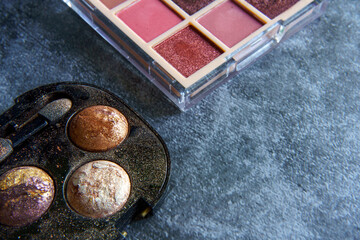 Eyeshadow pallet with an applicator brush.