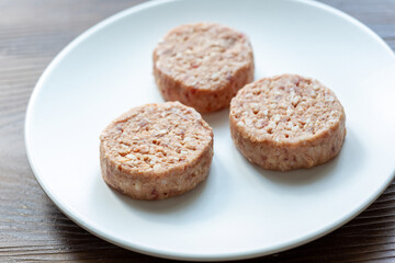 Three Plant-Based Meatballs on a White Plate