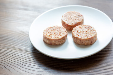 Three Plant-Based Meatballs on a White Plate