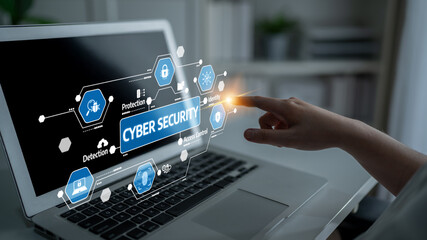 A person interacts with cyber security visuals on a laptop, emphasizing digital protection, data...