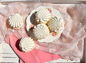 Beautiful marshmallows on decorated plate top view