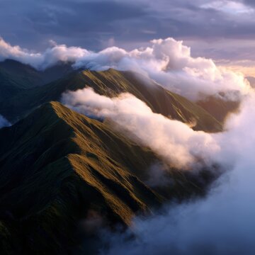 mountain ridge with clouds rolling through valleys, dramatic sunrise light
