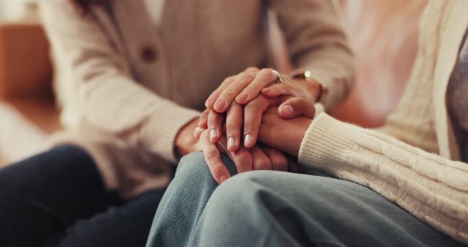 Friends, holding hands and empathy in home for trust, compassion and women with grief and helping. House, care and patience for person in living room, consoling or understanding of trauma or kindness