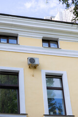 air conditioner is mounted on the wall. technologies for air cooling in hot weather. air temperature, climate control. ventilators in the home and office. installation of an air ventilation system.