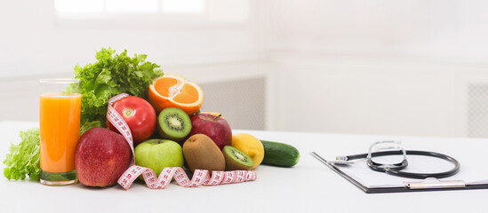 Doctor nutritionist's workplace with healthy organic food and stethoscope, panorama, copy space