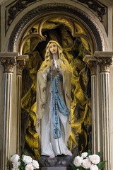 The Virgin Mary carved in a Christian altar in a church.
